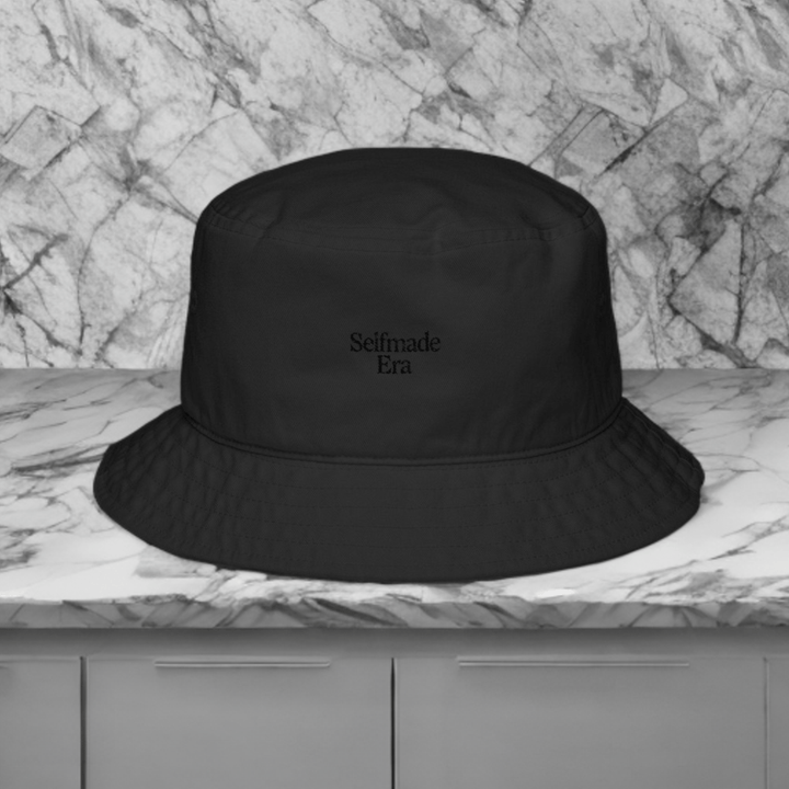 Era Embroidered Hat - Selfmade EraHatsSelfmade EraEra Embroidered Hat in black with tonal text, styled on a marble surface for a minimalist and fashionable streetwear look.